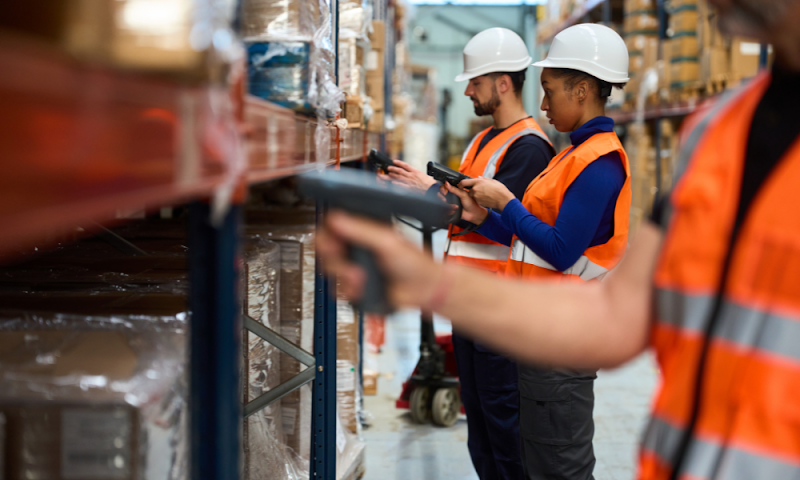 Warehouse staff scanning shelf items during a cycle count to verify inventory accuracy.